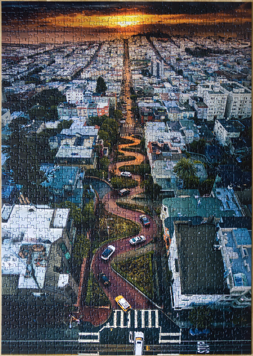 Aerial view of Lombard Street in San Francisco at sunset.