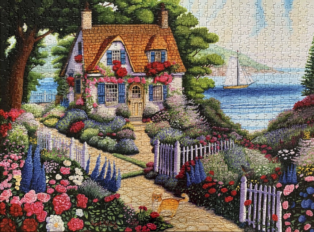 An illustration of a stone cottage with a lush garden, a white picket fence, and a sailboat on the water.