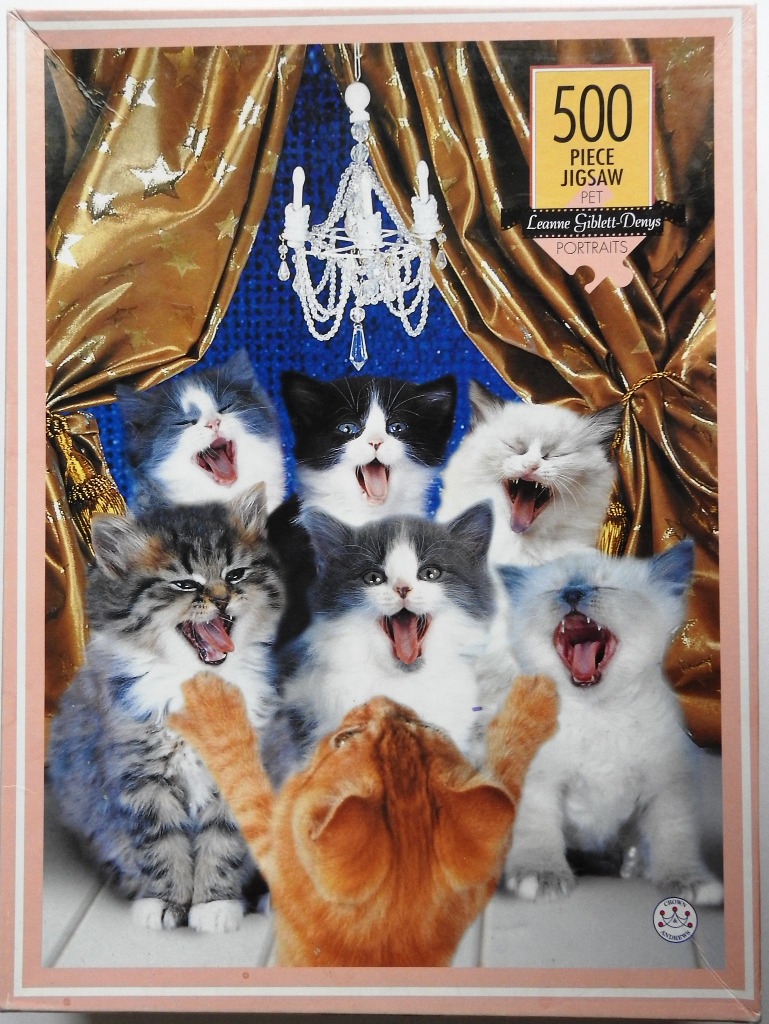 Six kittens yawning in front of a ginger kitten with its paws raised, set against a gold curtain and blue background.
