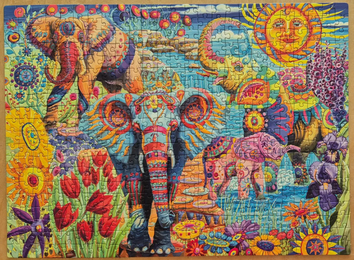 A vibrant, psychedelic illustration of elephants surrounded by colorful flowers and a stylized sun.