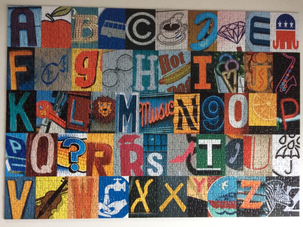 A collage of individual square panels, each featuring a letter of the alphabet paired with a corresponding object.