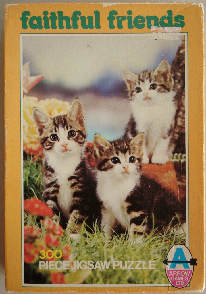 Three tabby and white kittens sitting in a grassy garden, with the text 'faithful friends' above them.