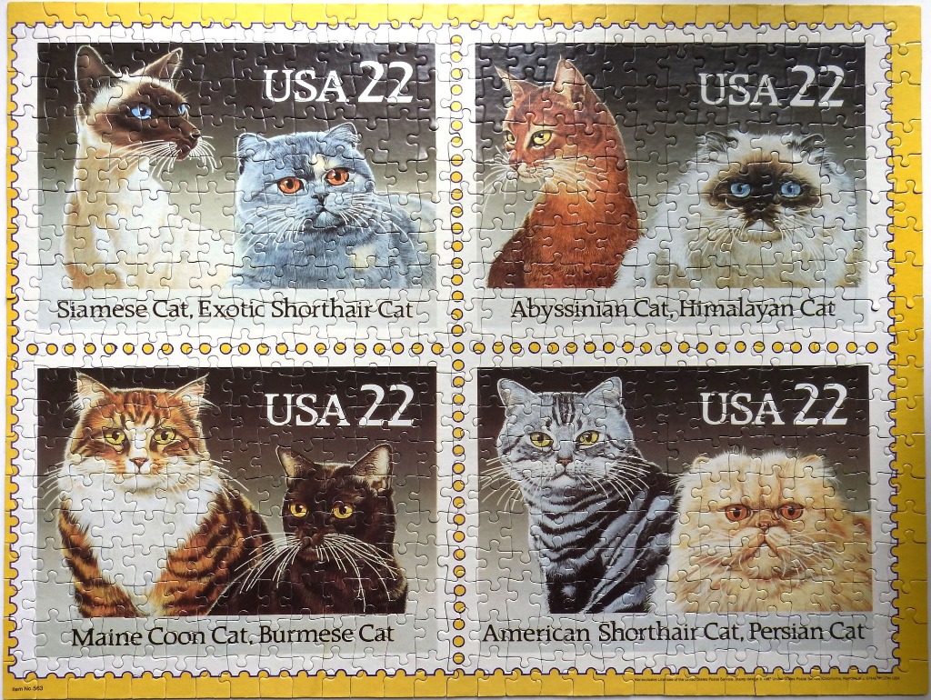 Four postage stamps featuring portraits of various cat breeds