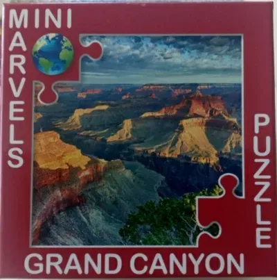 A panoramic landscape photograph of the Grand Canyon showcasing rocky plateaus under a dramatic sky.