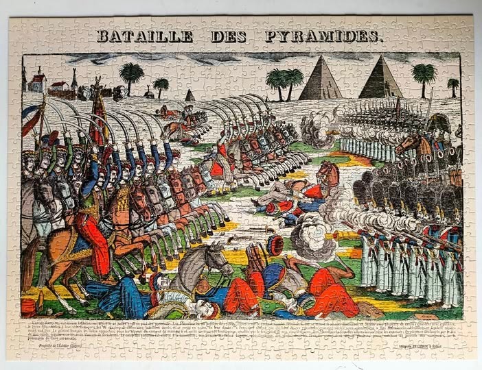 A historical print-style illustration of the Battle of the Pyramids with soldiers, horses, and iconic monuments.