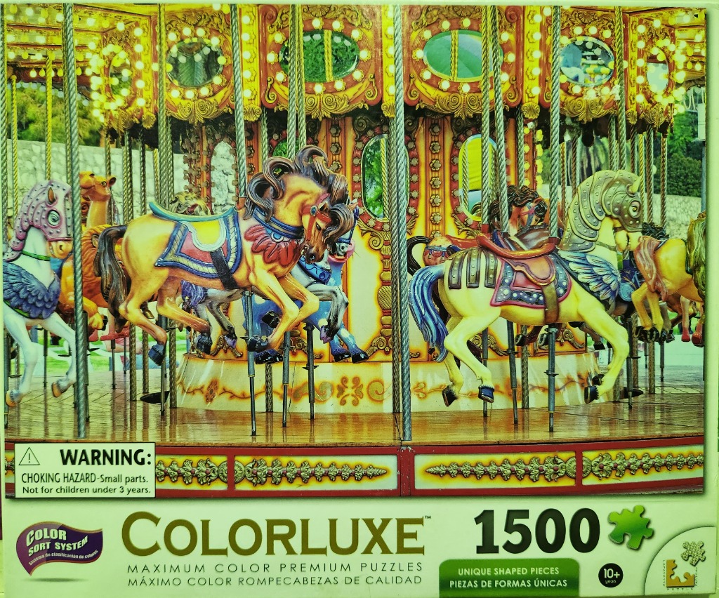 A brightly colored vintage carousel featuring ornate horses and golden architectural details.