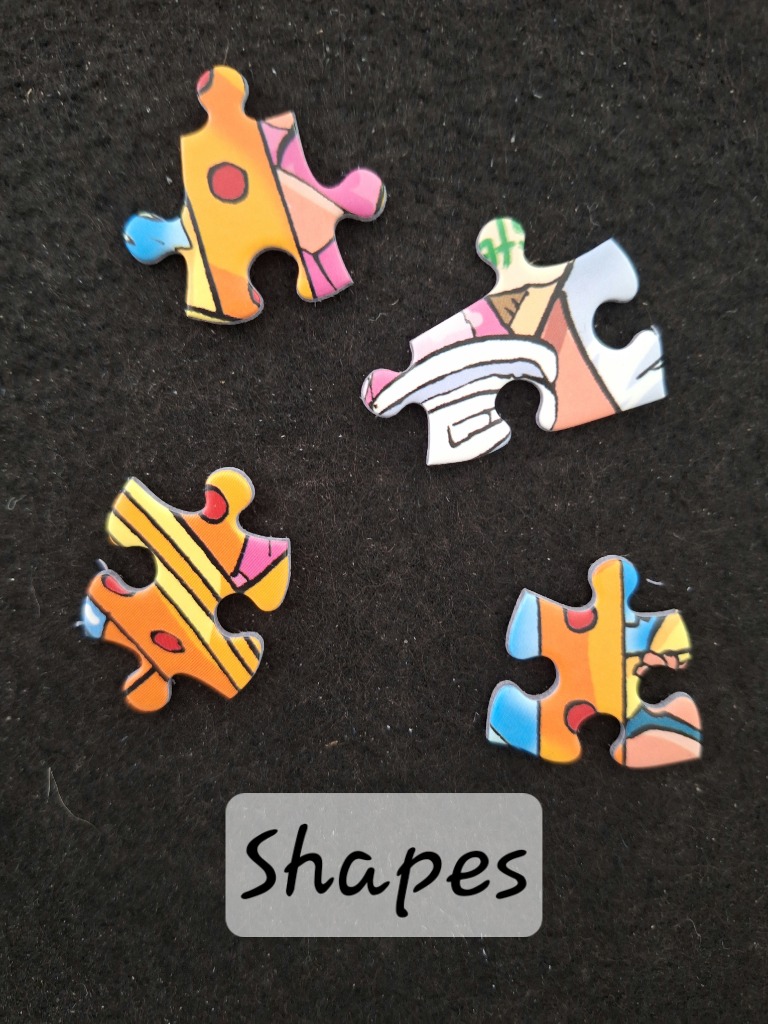 Four colorful abstract graphic segments with bold outlines against a black background.