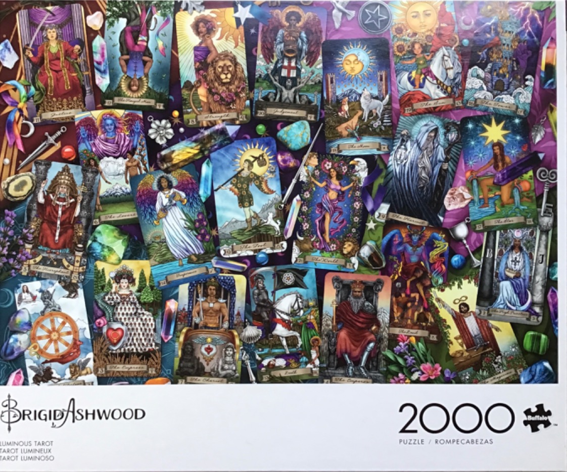 A collage of various colorful tarot cards arranged among sparkling crystals and mystical items.