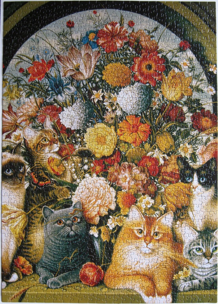 A group of five cats sitting in front of a lush floral bouquet within an arched stone alcove.