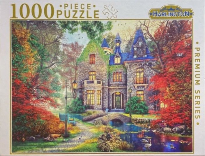 A stone manor house with blue turrets surrounded by autumn trees and a small pond with swans.
