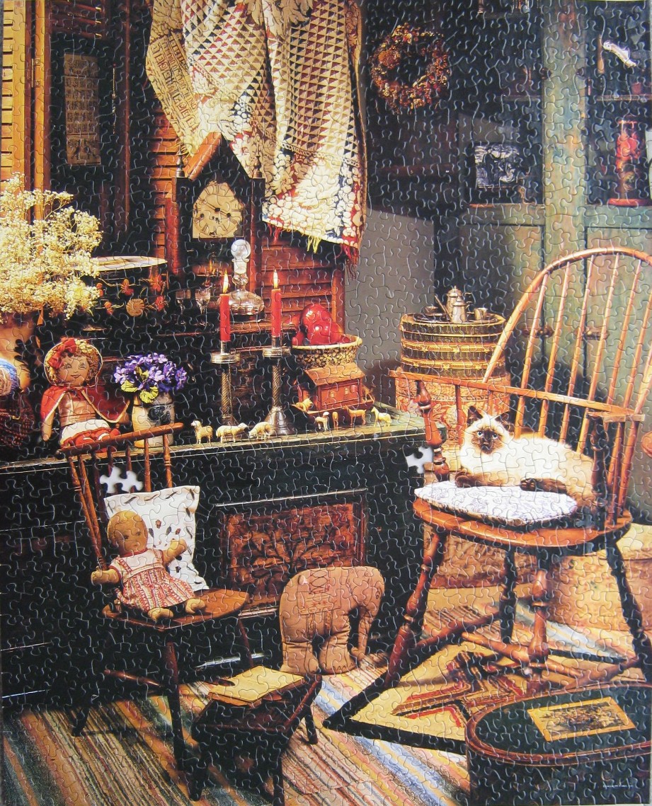 A cozy, rustic room filled with antique dolls, a Siamese cat in a wooden chair, and vintage home decor.