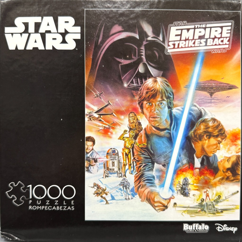 Classic illustrated movie poster for The Empire Strikes Back featuring Luke Skywalker with a lightsaber and Darth Vader.