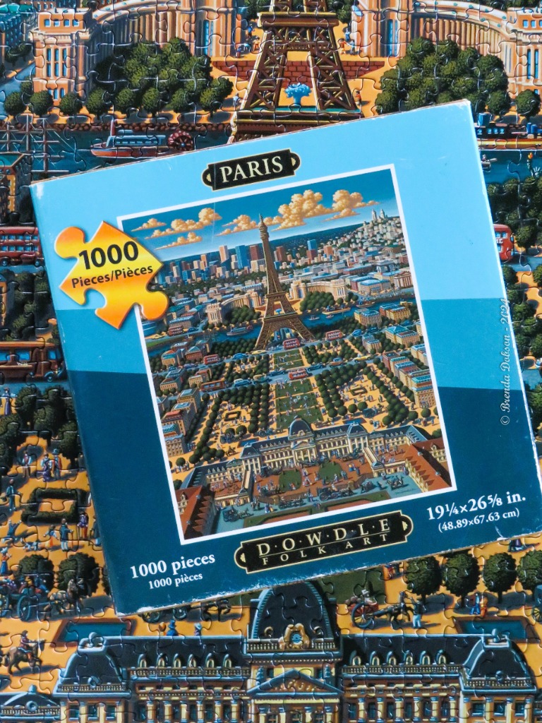 A whimsical folk art illustration of the Eiffel Tower and Paris city center.