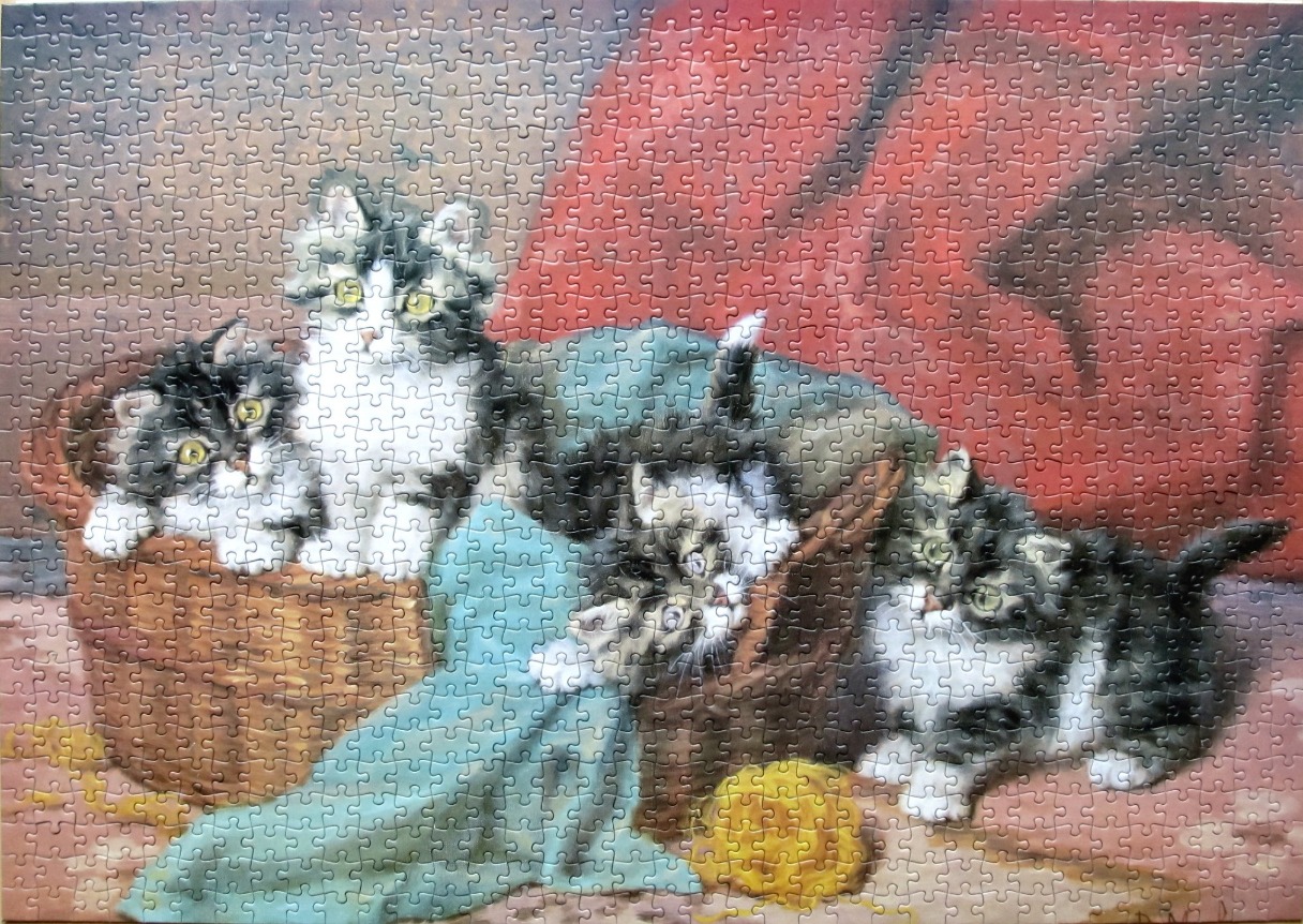 Painting of four fluffy kittens in and around a wicker basket with a blue cloth and yellow yarn.