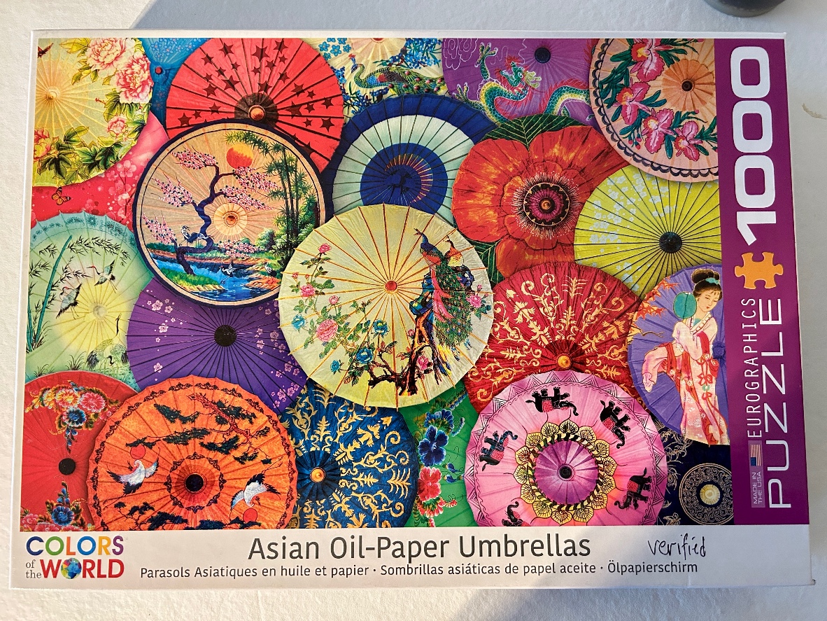 A collage of various colorful Asian oil-paper umbrellas featuring floral, bird, and landscape designs.