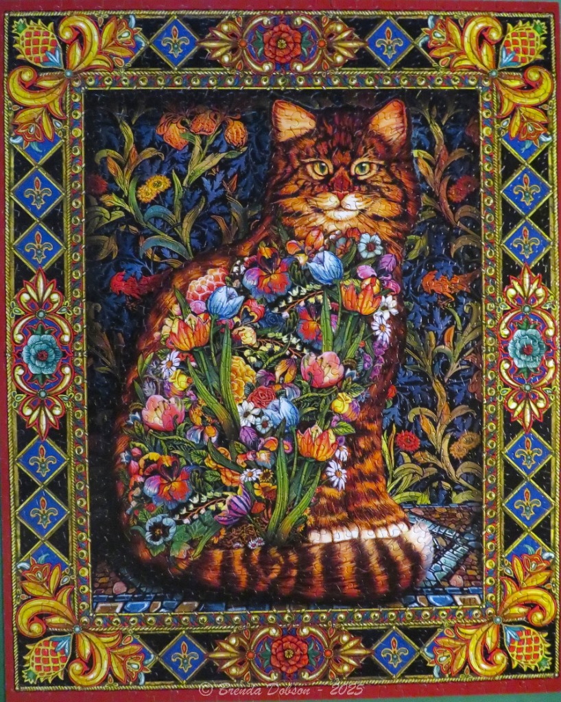 A regal tabby cat surrounded by vibrant flowers, framed in a rich, decorative Victorian-style border.