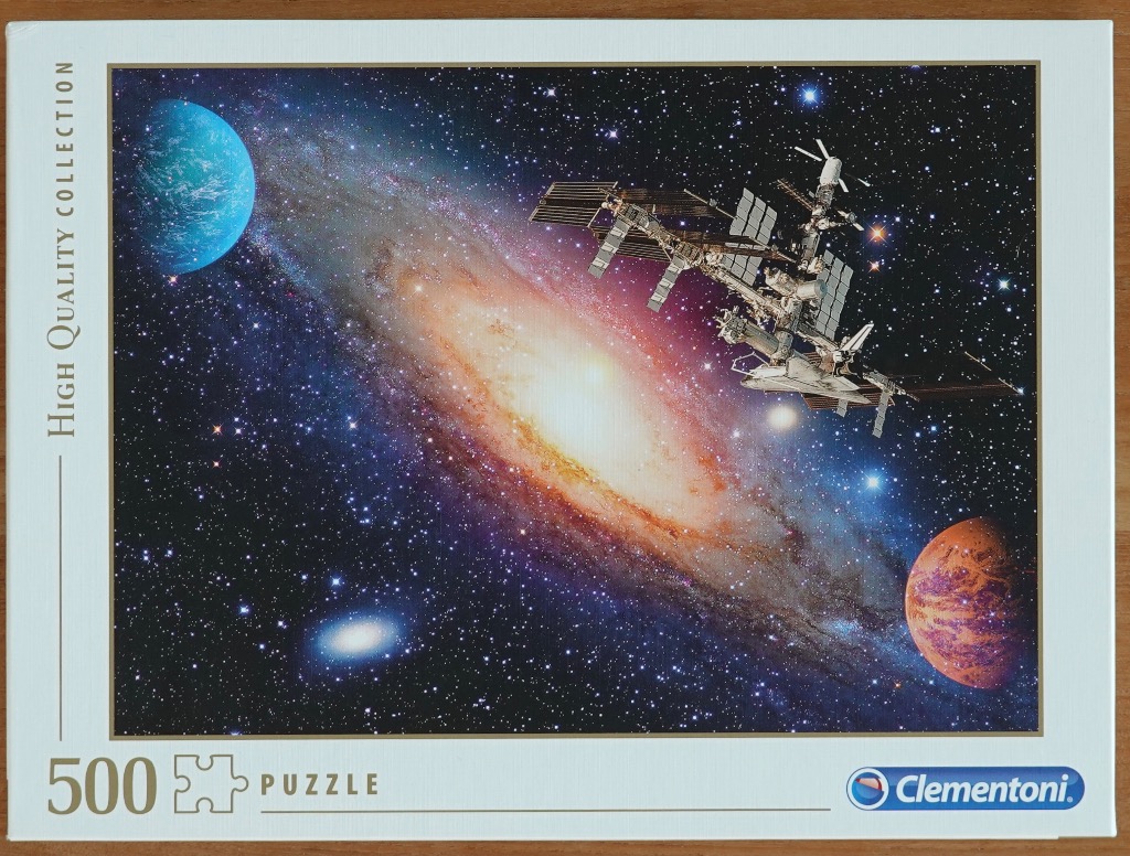 A space scene featuring a bright spiral galaxy, a space station, and two planets against a starry background.