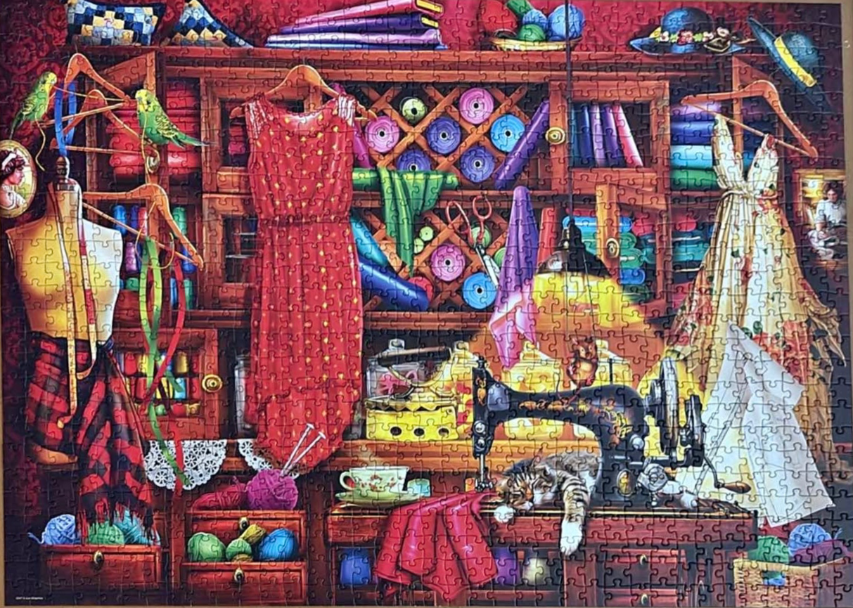 A cozy, vibrant sewing room filled with fabric, dresses, and a sewing machine with a cat resting nearby.