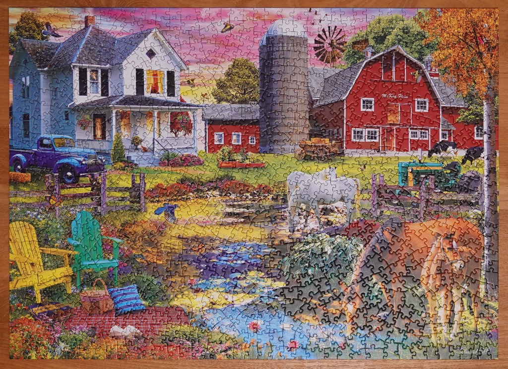 A vibrant rural farm scene featuring a white farmhouse, red barn, horses, and a picnic area under a pink sunset.