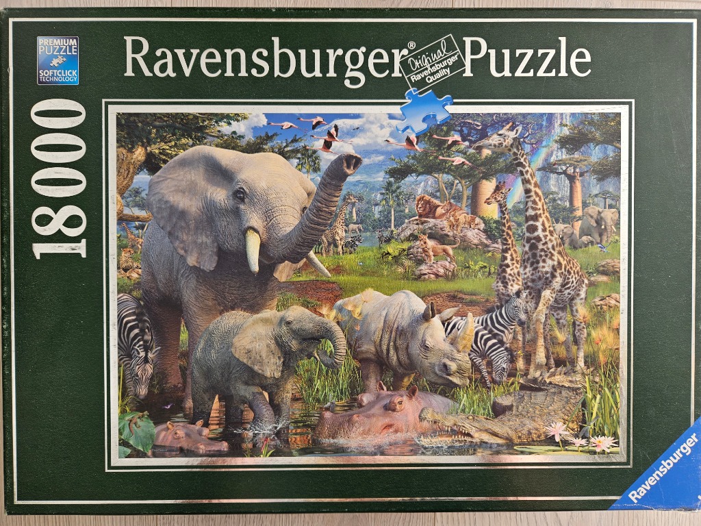 A lush African savanna scene featuring diverse wildlife including elephants, giraffes, zebras, a rhino, and a hippo.