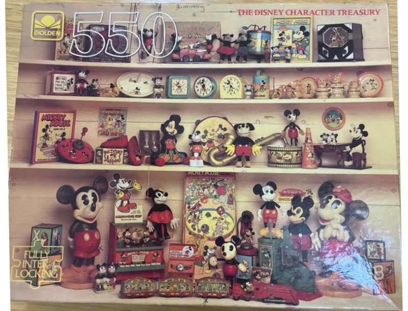 Vintage collection of Mickey Mouse toys and memorabilia arranged on wooden shelves.
