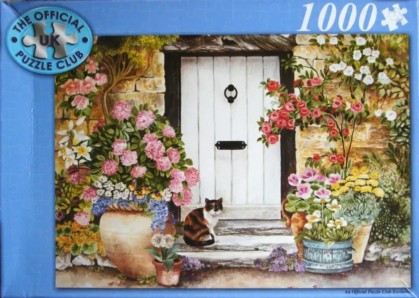 A painting of a calico cat sitting in front of a white door surrounded by potted flowers.