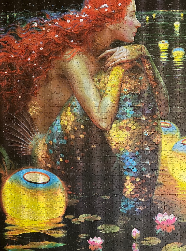 A red-haired mermaid sitting at the edge of a dark pond with glowing lanterns and water lilies.