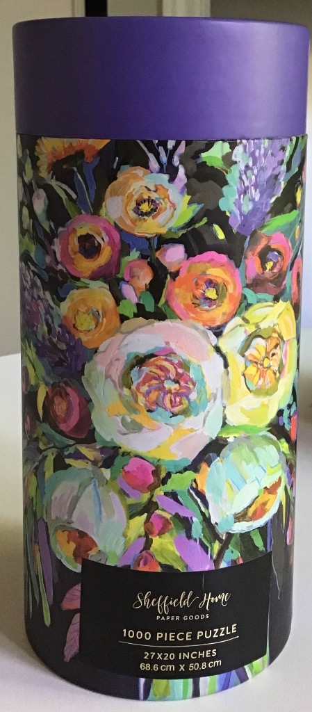 Colorful, loose, painterly floral bouquet against a dark background.