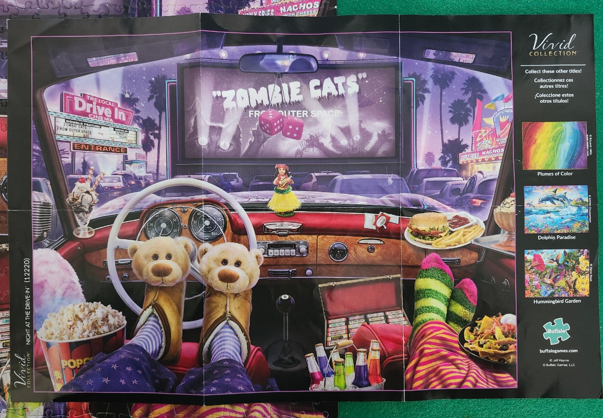 Interior view of a vintage car parked at a drive-in theater showing a movie called Zombie Cats.