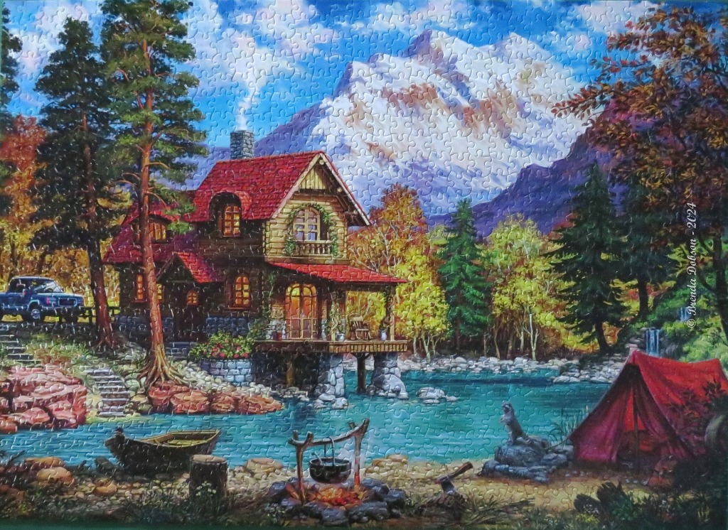 A cozy log cabin and lakeside campsite nestled beneath snow-capped mountains.