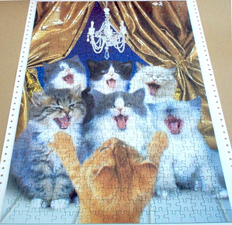 A whimsical illustration of a group of six kittens with open mouths as if singing under a crystal chandelier.