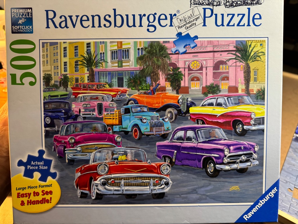 A vibrant illustration of classic vintage cars parked in front of a colorful, Mediterranean-style building.