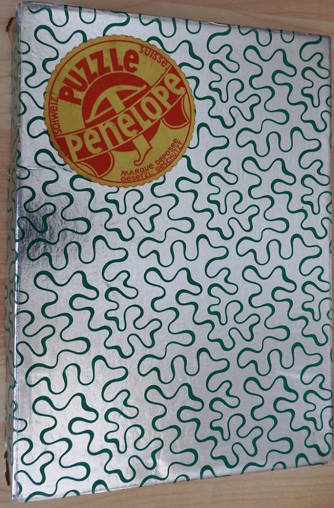 A repeating pattern of green wavy lines on a metallic silver background with a circular label in the top left corner.