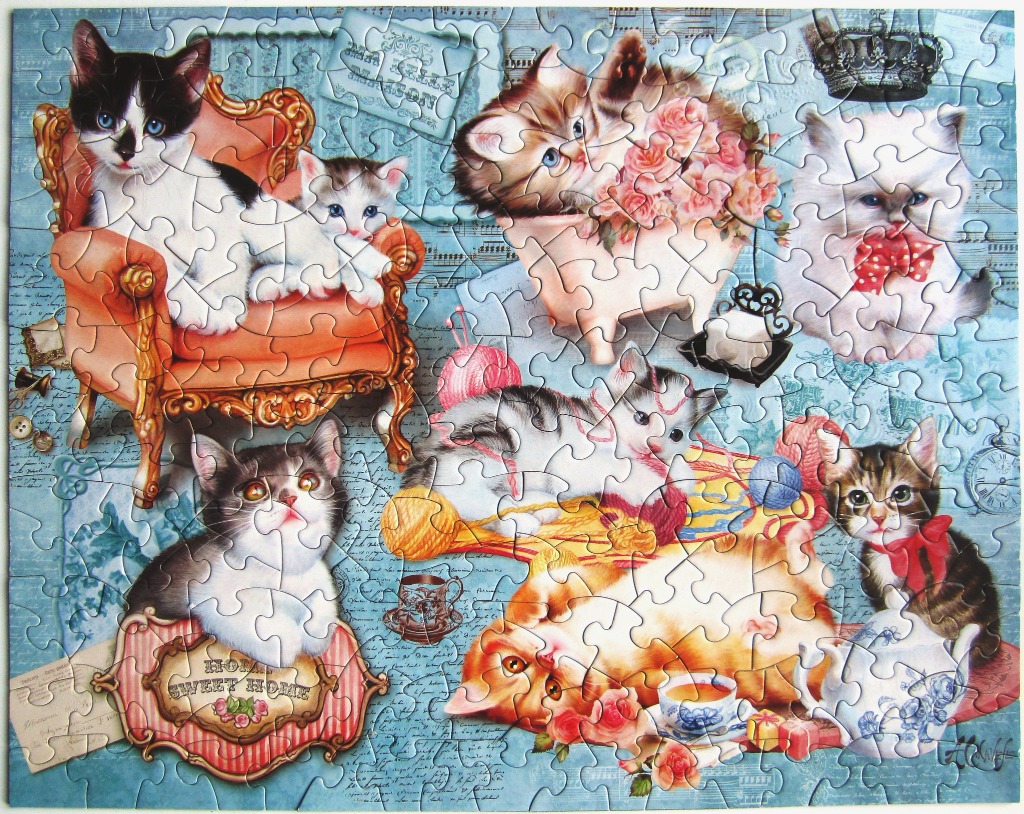A collage of seven kittens depicted in an ornate, vintage-inspired illustration with roses and tea sets.
