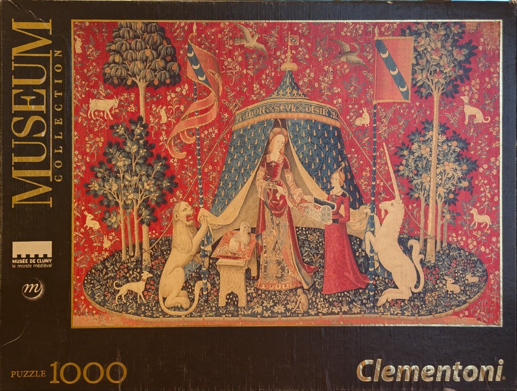 The Lady and the Unicorn tapestry depicting a woman with a unicorn and a lion in a flowery red garden.