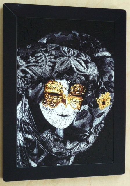 A close-up illustration of a Venetian masquerade mask wearing a lace headpiece in black, white, and gold.