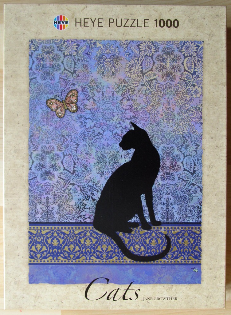 A black cat silhouette sits before a patterned purple tapestry with a butterfly nearby.