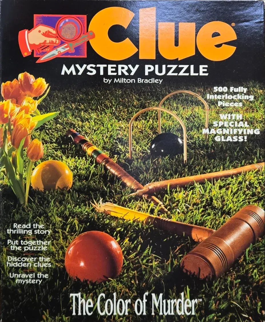 A croquet set on a grassy lawn with orange tulips nearby.