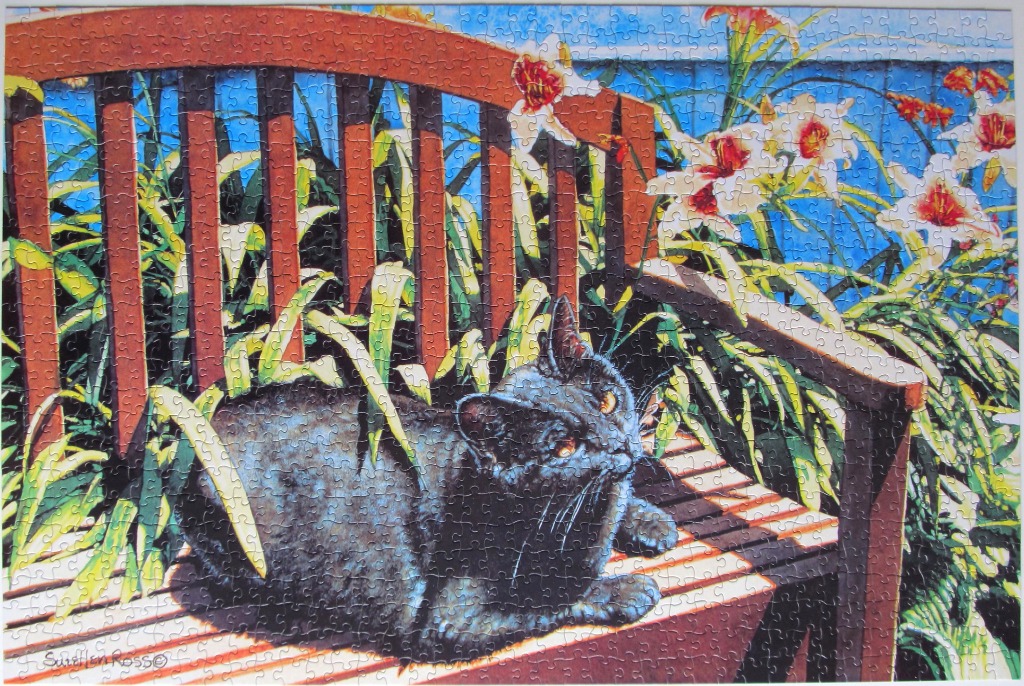 A black cat resting on a wooden garden bench surrounded by white and orange lilies against a vibrant blue background.