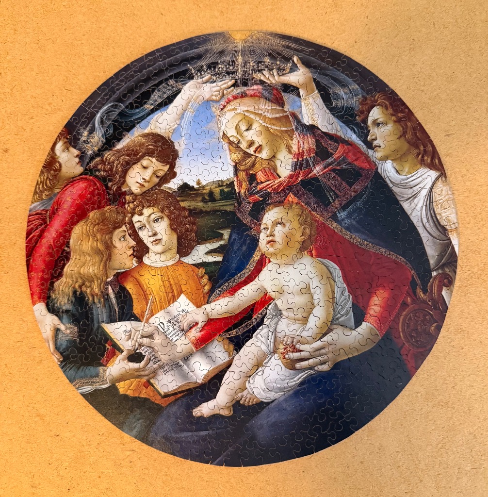 A circular Renaissance-style painting of the Virgin Mary and the Christ child surrounded by four angels.