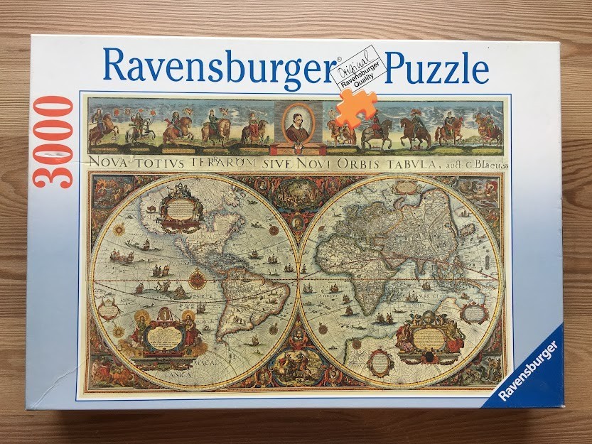 A vintage-style double-hemisphere world map featuring ornate borders, sailing ships, and historical figures.
