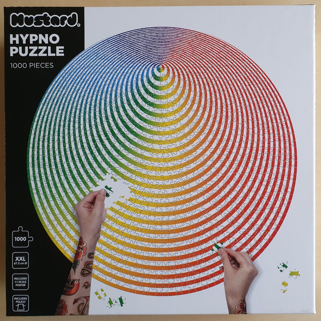 A circular spectrum of radiating rainbow colours forming an optical illusion on a white background.
