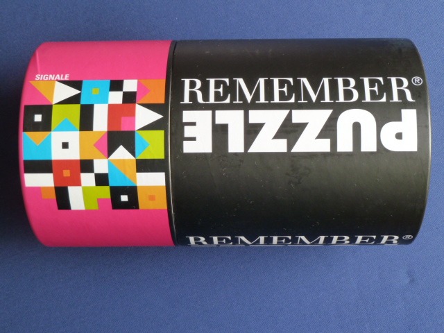 Abstract geometric design with colorful squares and triangles on a pink background next to black branding.