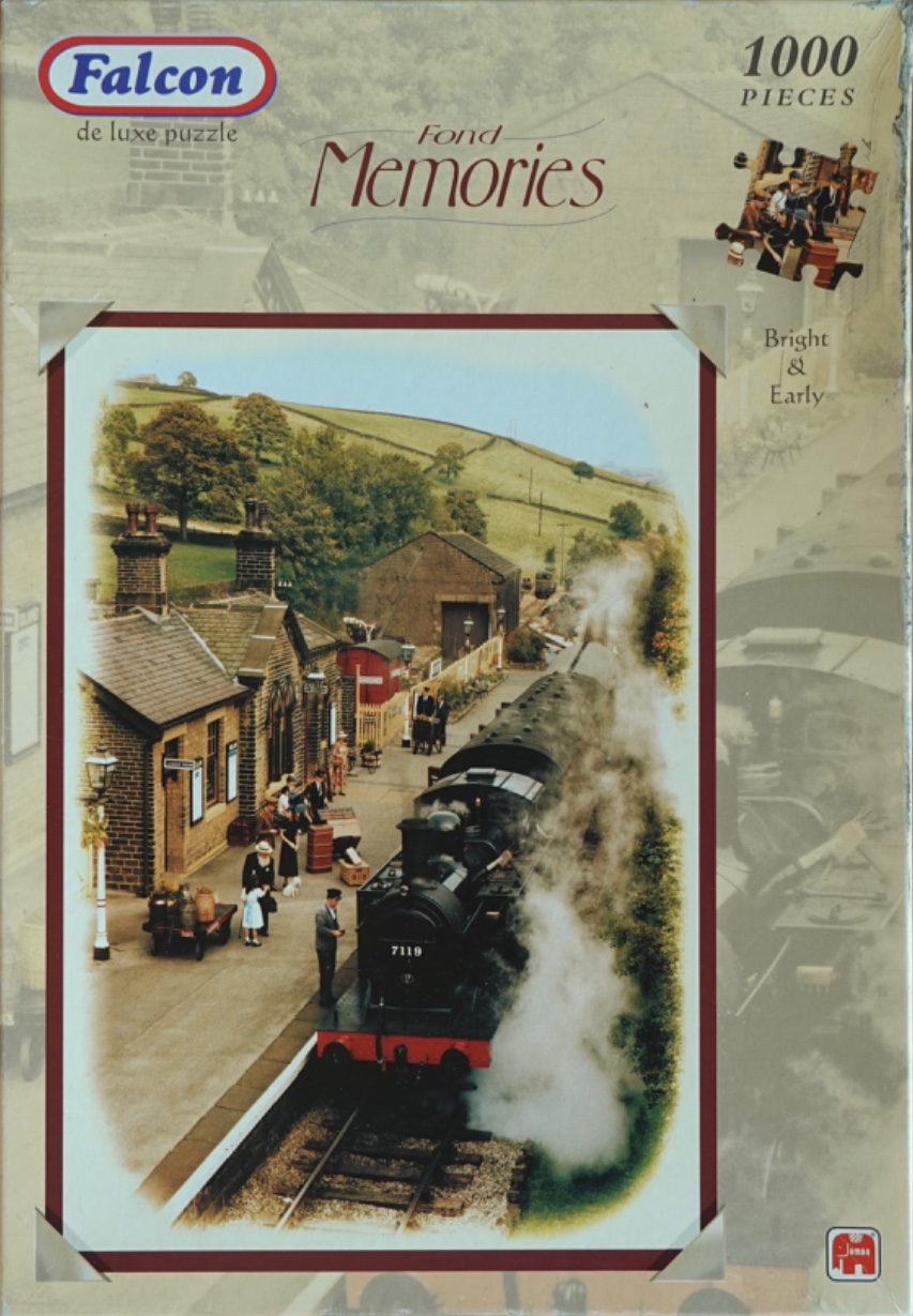 A vintage steam locomotive pulling into a small English countryside station with passengers waiting on the platform.