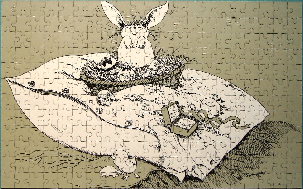 Whimsical ink illustration of an Easter bunny in a basket on a pillow with eggs and a chick.