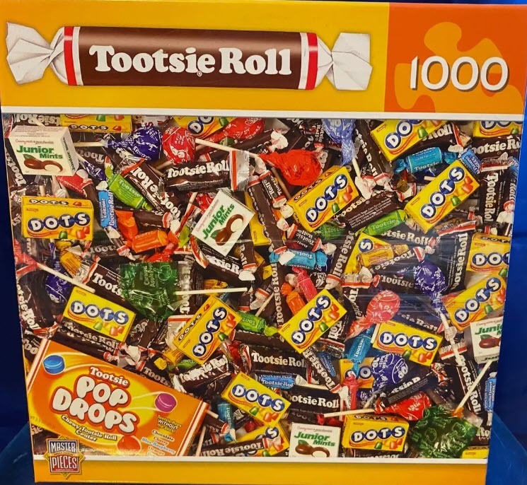 A dense, colorful collage of various Tootsie brand candies including Tootsie Rolls, DOTS, and Junior Mints.