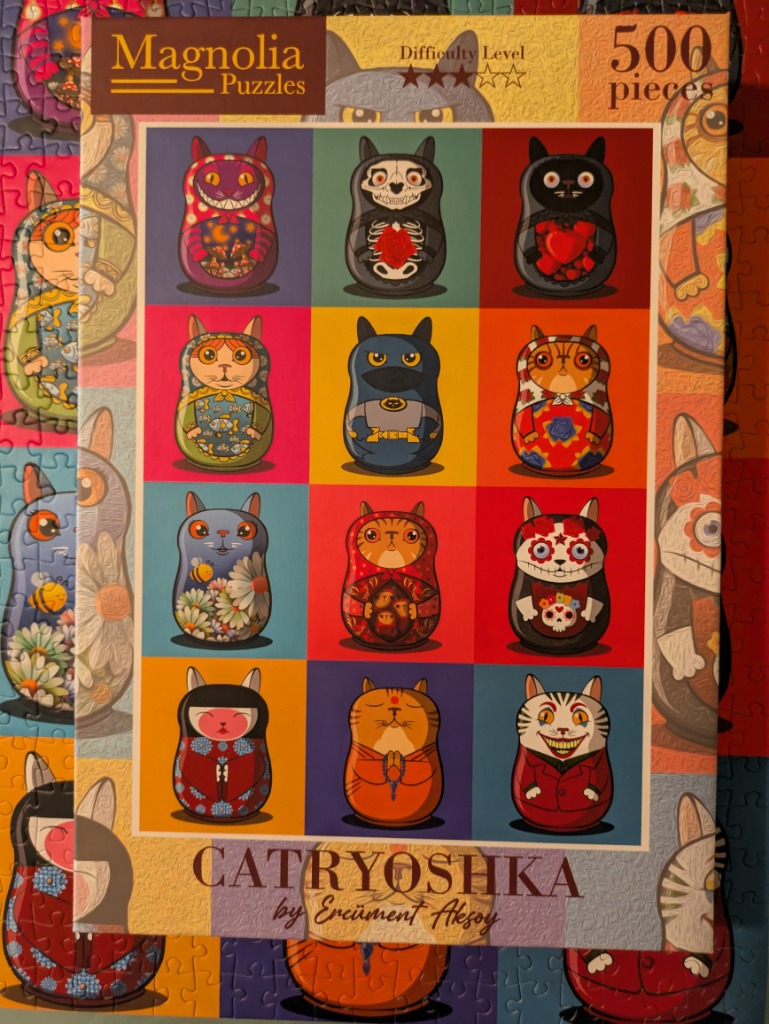 A grid of twelve stylized cat-shaped Russian nesting dolls, each with a unique artistic theme.