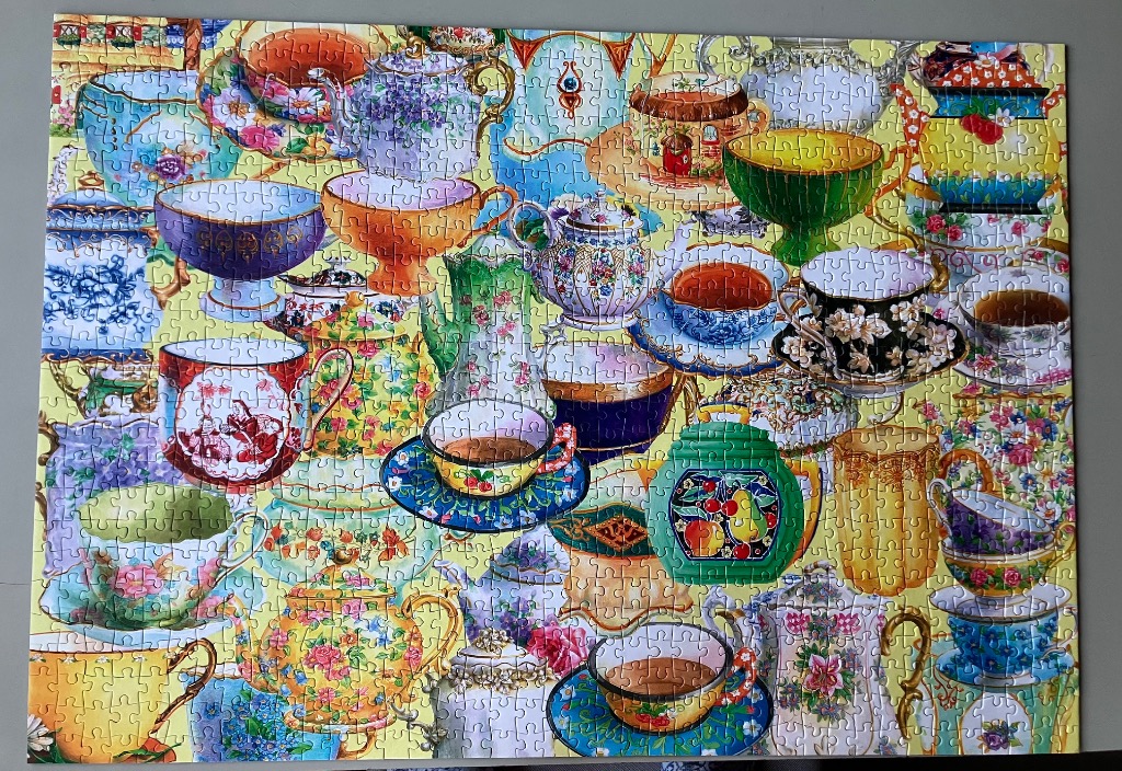A collage of various ornate teacups and teapots in many colors and floral patterns
