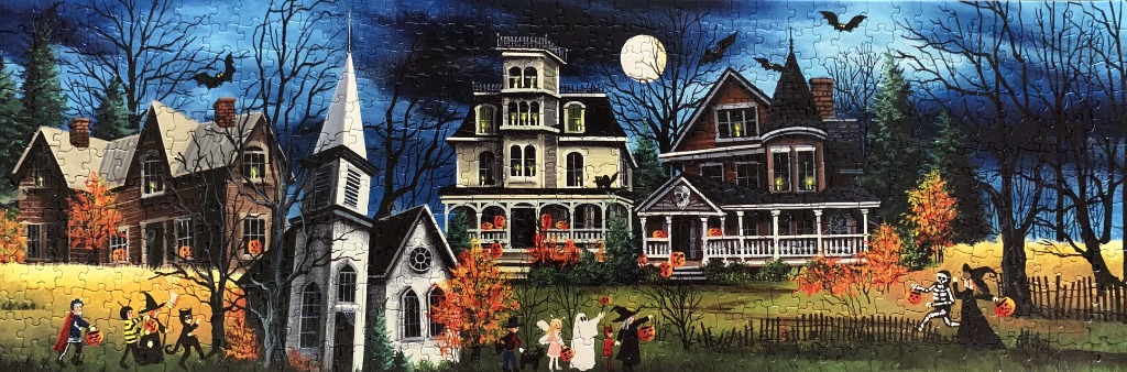 A Halloween night scene with trick-or-treaters in front of three spooky houses under a full moon.
