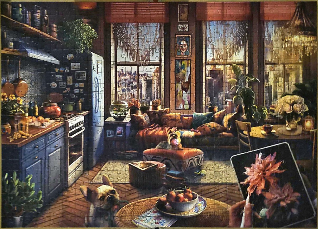 Cozy, art-filled apartment interior with a city view, dogs, and a tablet in the foreground.